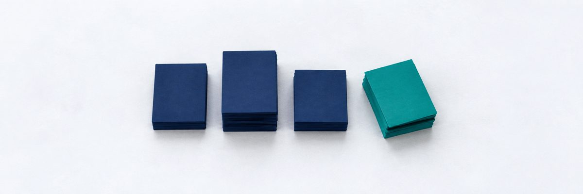 Four stacks of cards in a row, one tipped and separated